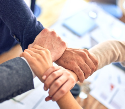 Team collaboration symbolized through joined hands reflecting unity shared goals and a strong work culture